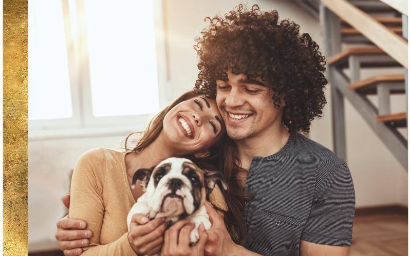 a man and woman holding a dog